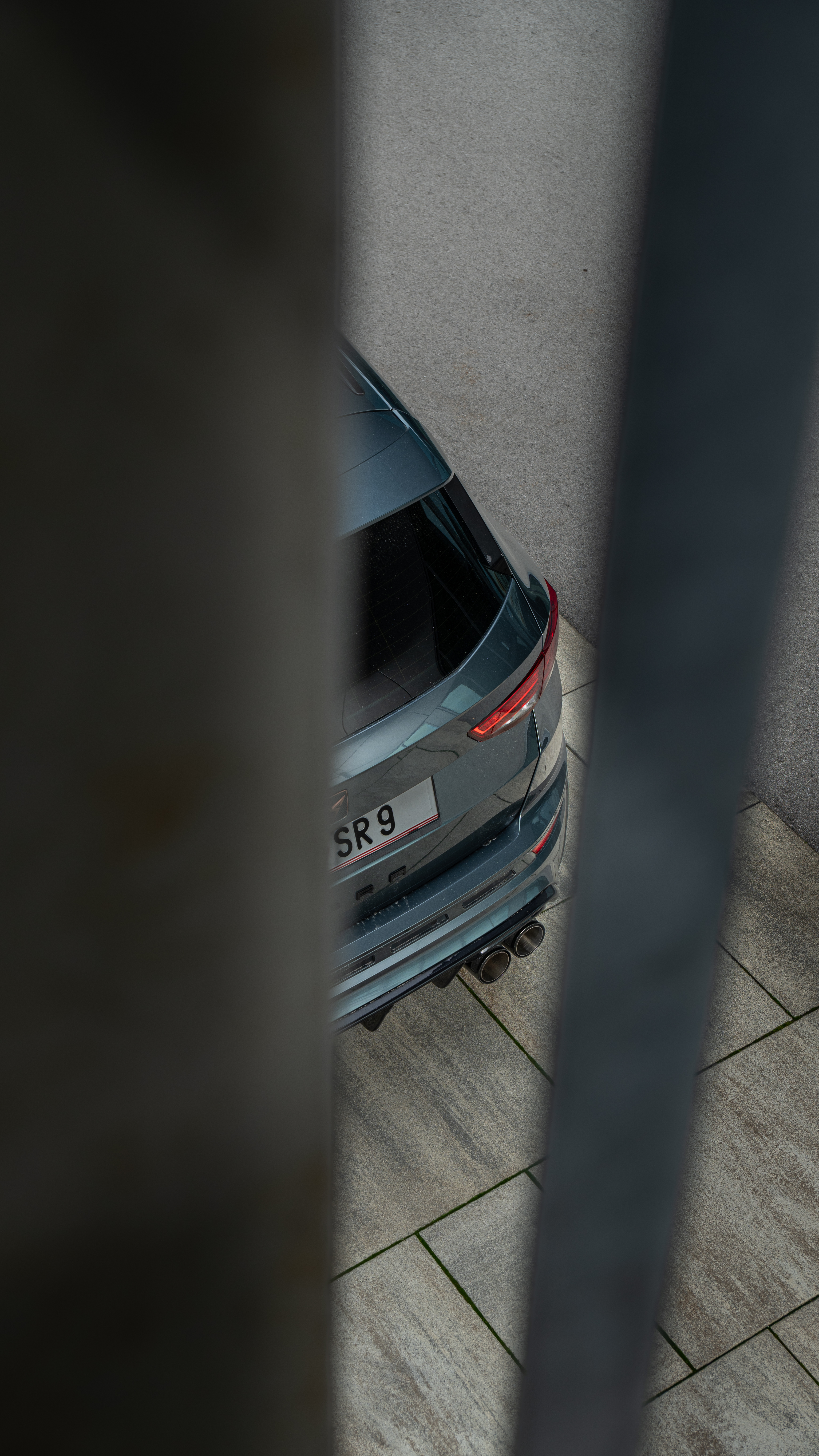 Cupra Ateca rear detail photographed through foreground elements with a cinematic style