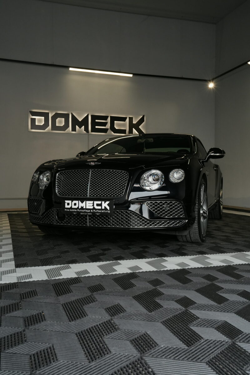 Bentley front view photographed in a detailing studio with premium automotive lighting